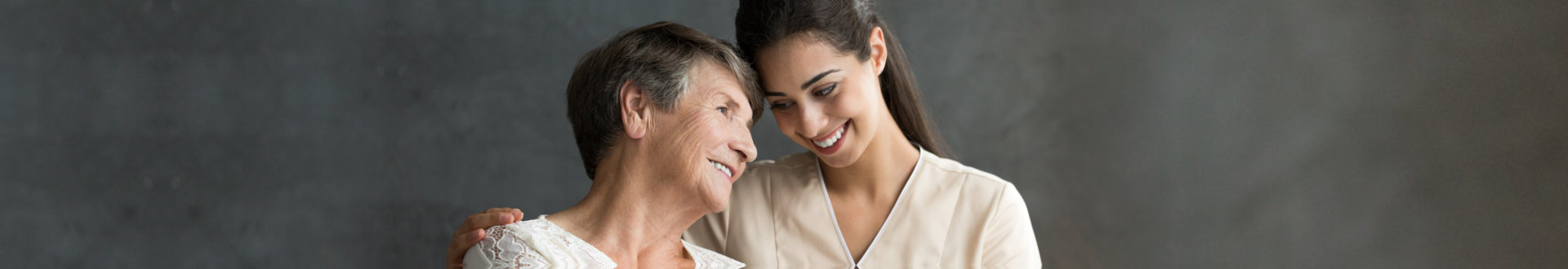 senior woman with female caregiver smiling